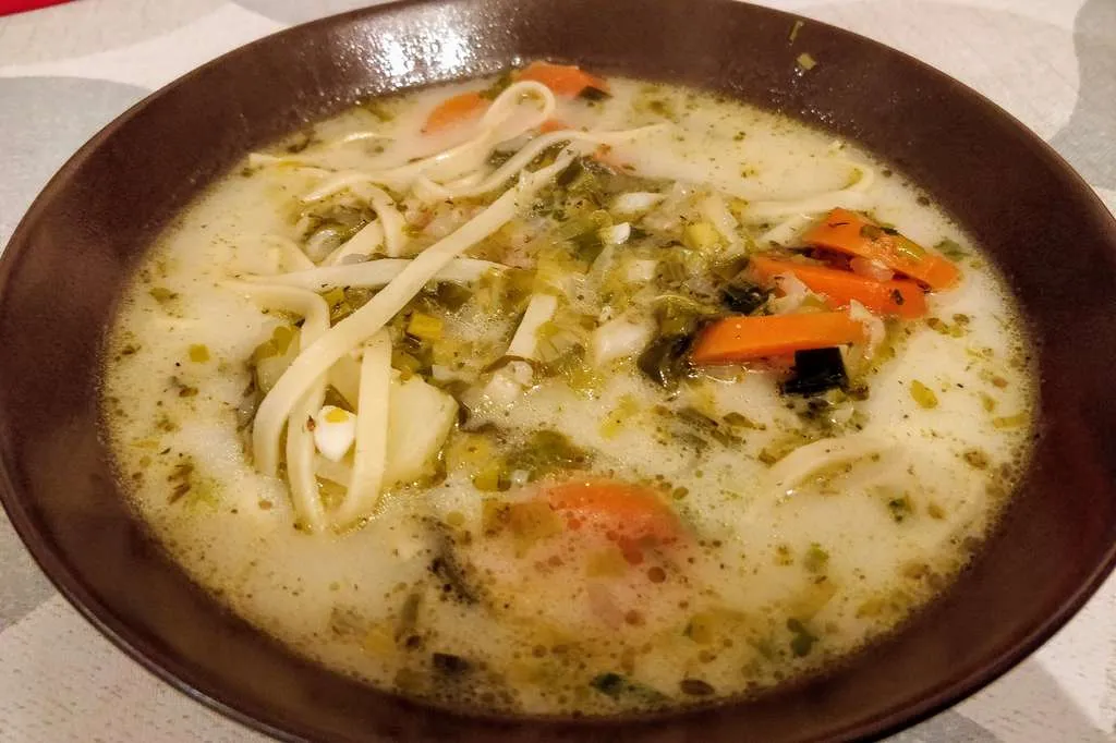The same soup served with noodles added