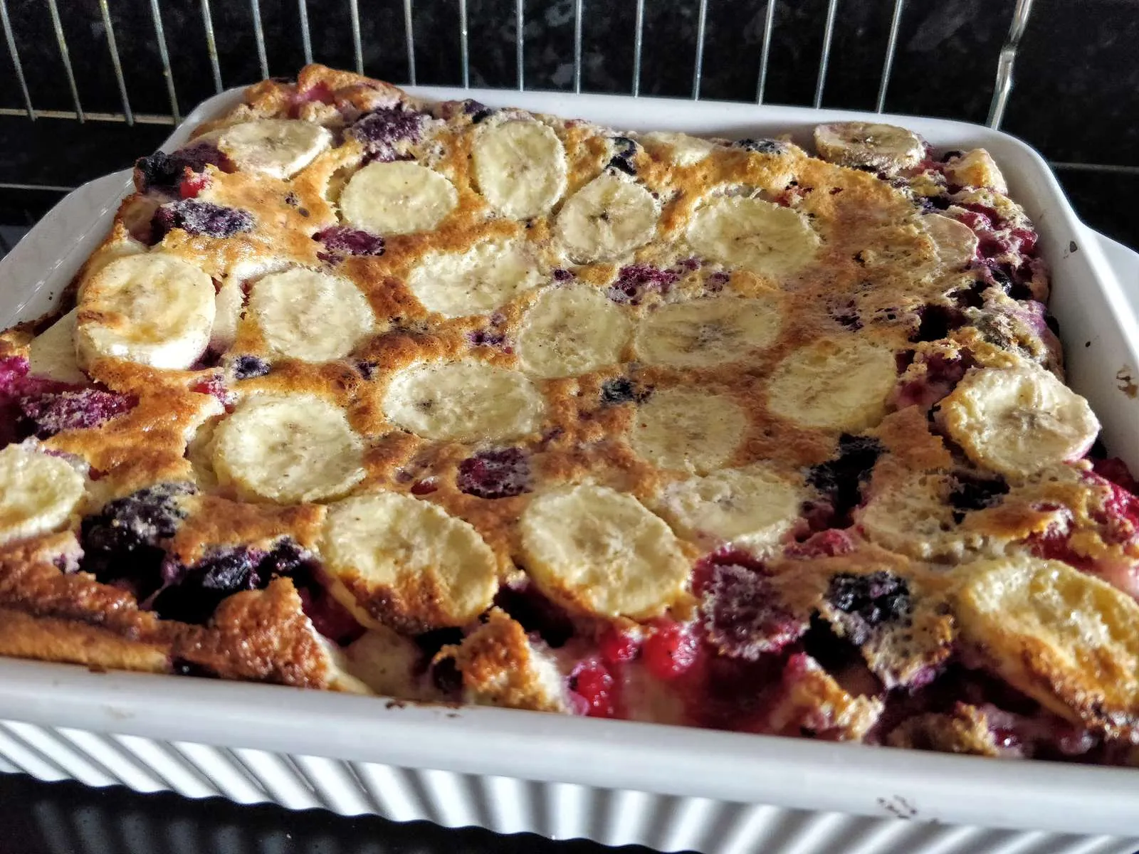 Banana and berry custard, baked and served in a dish